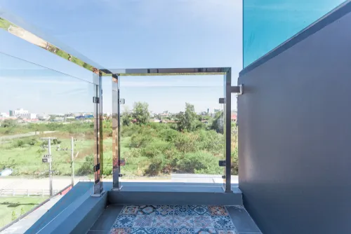 Glass and steel balcony with hand railings