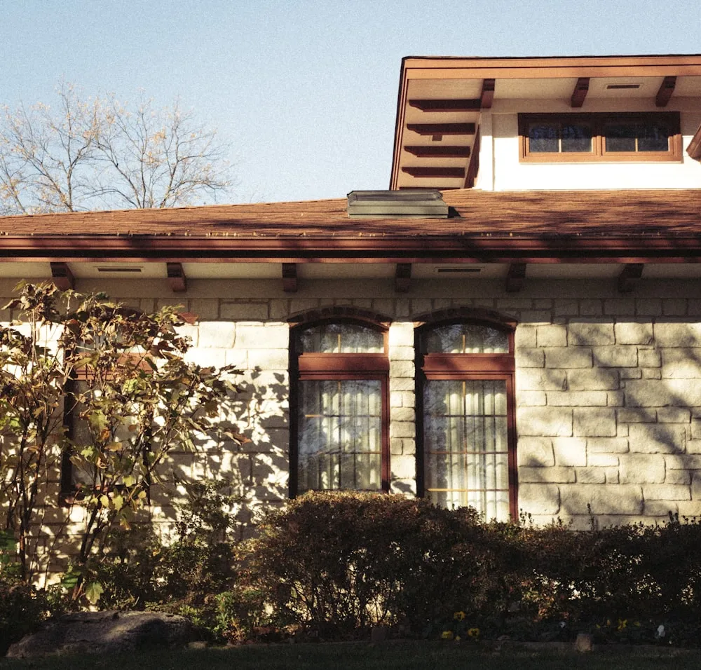 brown brick building with green plants